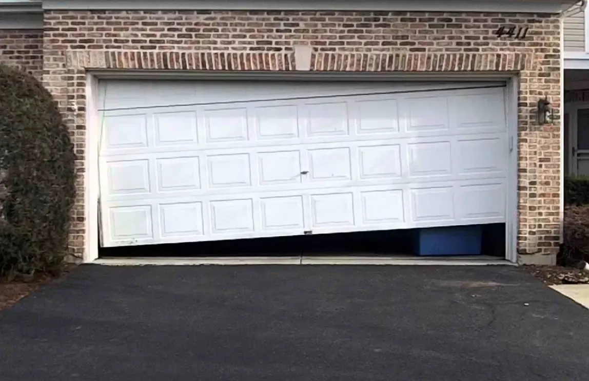 Crashed garage door requiring emergency repair