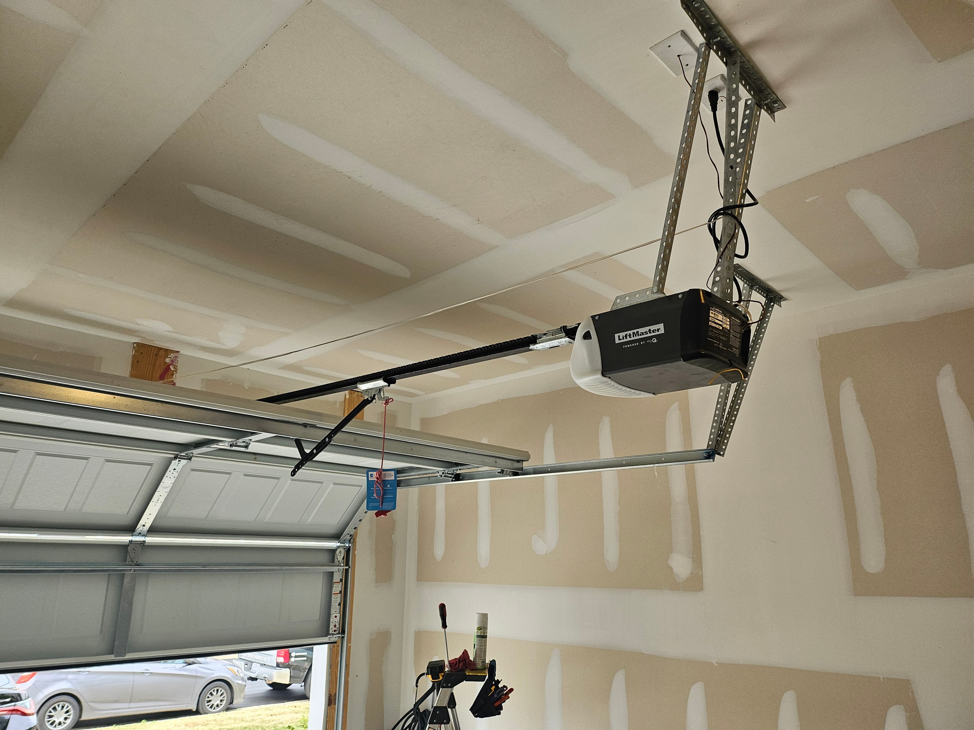 Crashed garage door after vehicle impact in Whitsett NC