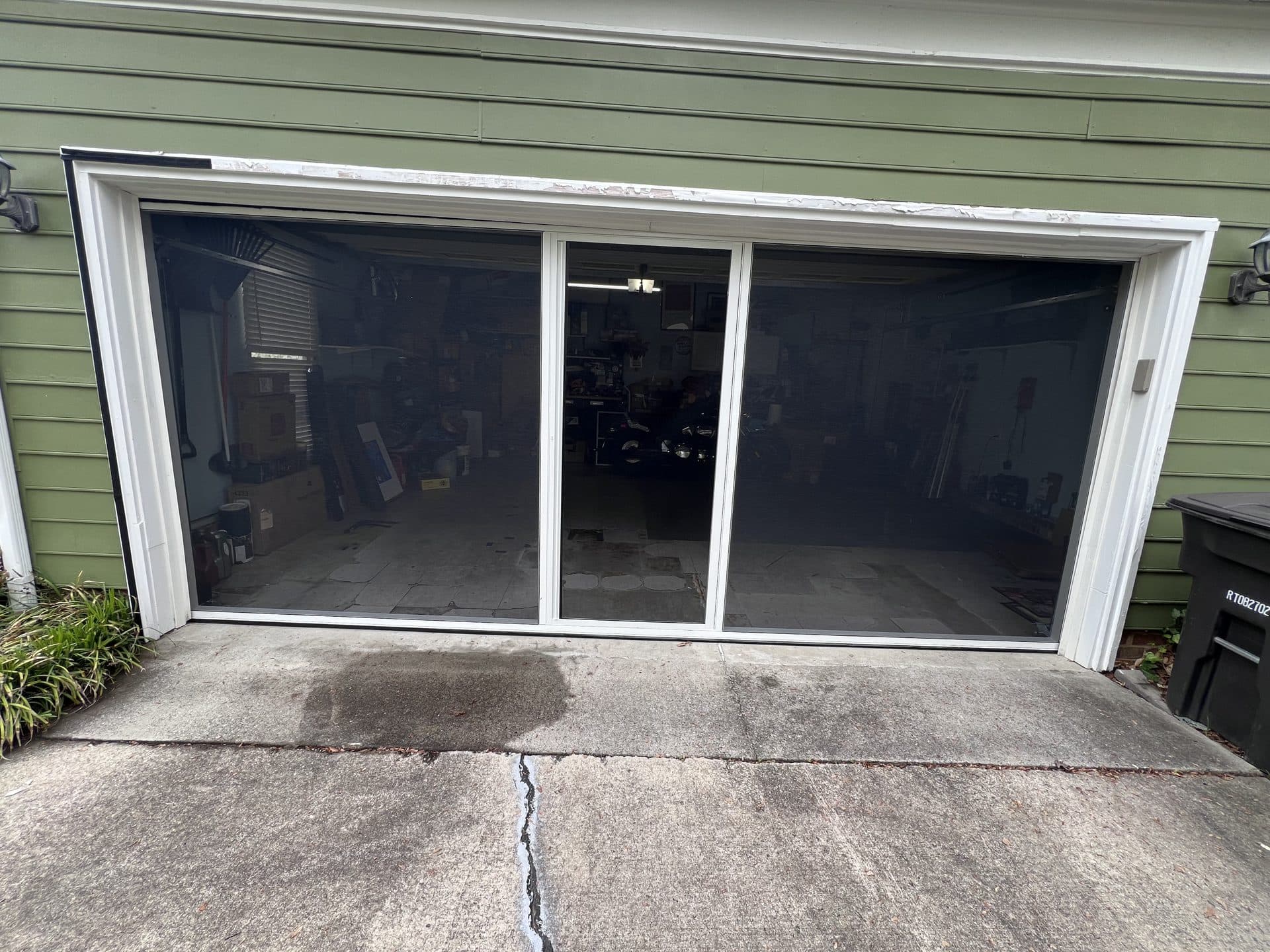 Completed retractable garage screen door on green house in High Point NC