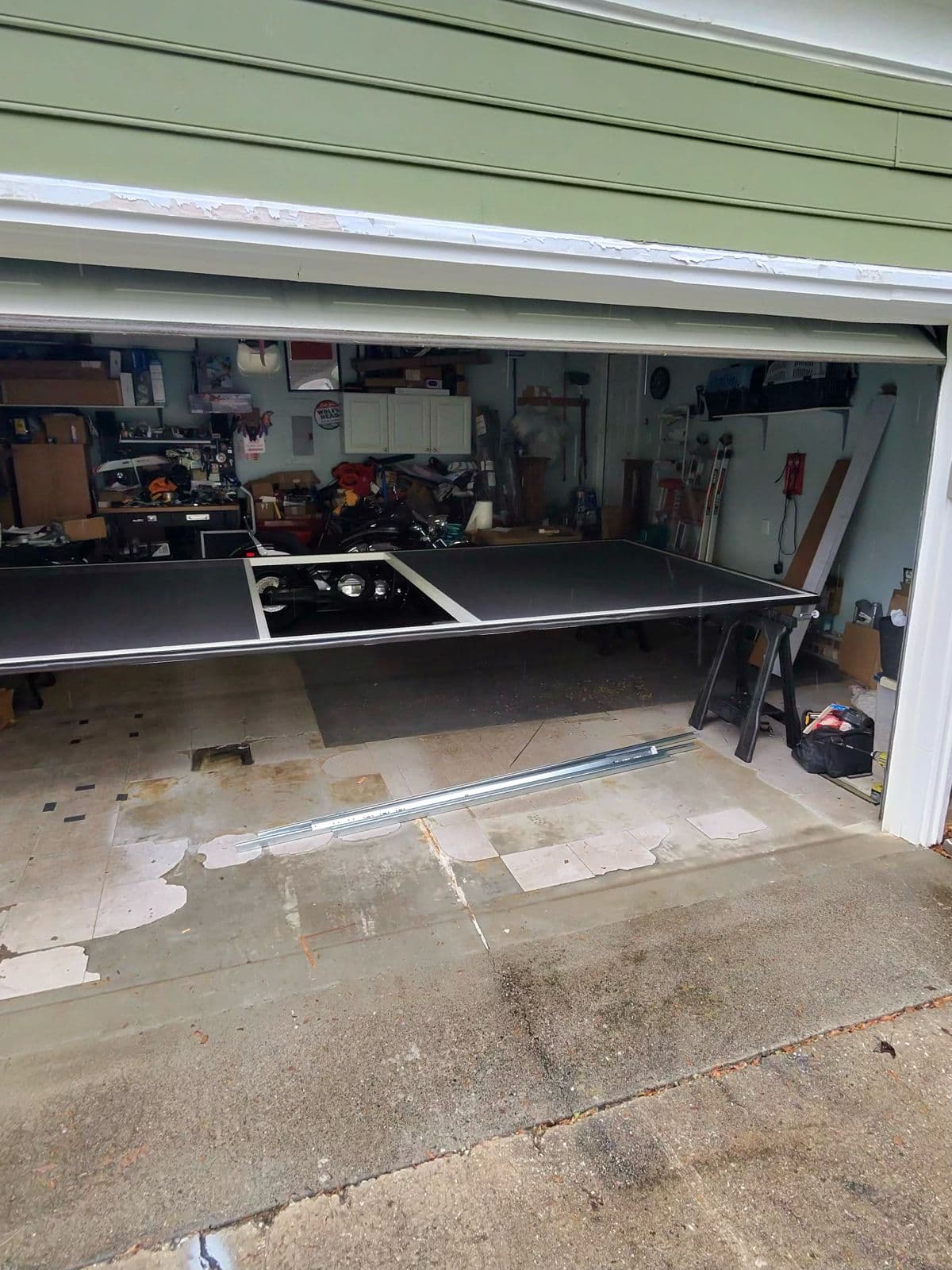 Garage before screen door installation showing old panel in High Point NC